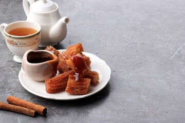 Homemade mini churros with dulce de leche