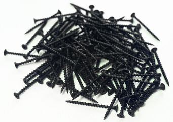 Black metal screws on wood ea white isolate. Lots of screws on a white background