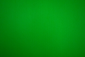 Photo of the texture of a green background made of felt fabric. Green stuff.