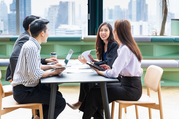 Team of young Asian entrepreneur have small team meeting for upcoming project for marketing and sale management with skyscraper view for business startup and education concept