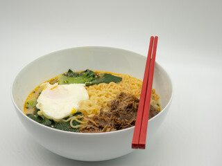 A bowl of egg, vegetable and beef noodles