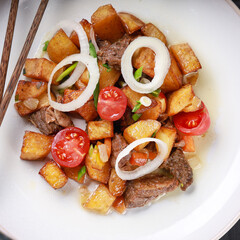 fried potatoes with meat food photography