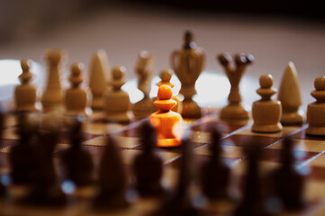 Chess pieces on a chessboard. The pawn is under pressure. Game concept. Conflict situation. Selective focus.