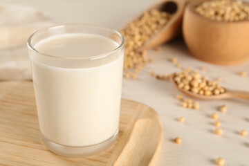 Fresh soy milk and beans on table, closeup. Space for text