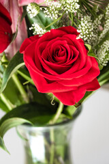 A lily and red rose bouquet on white