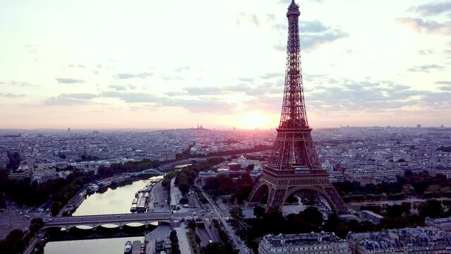 Elevated frone view of Eiffel tower with sun facing, tilting down to reveal tower and I&eacute;na bridge, paris skyline