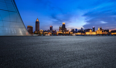 Fototapeta premium Asphalt road and city skyline with modern commercial buildings in Shanghai at night, China.