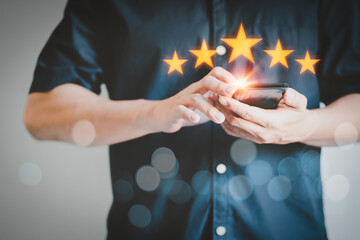 Man using a smartphone in give rating to service experience on application. Online customer review...