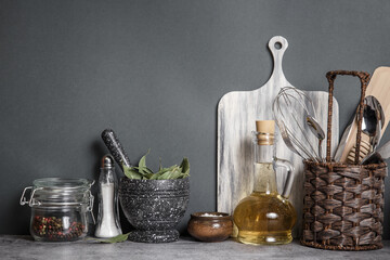 Kitchen utensils, crockery and spices in a home interior on a tabletop. Background with copy space front view