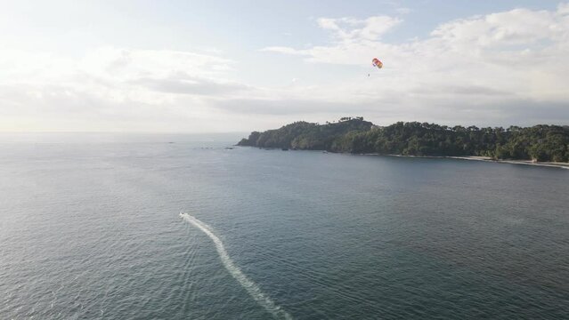 Parasailing along the stunning coastline of Manuel Antonio Beach on the Central Pacific Coast of Costa Rica. Wide angle aerial