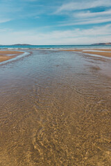beautiful scenary of the Brown River estuary meeting the Pacific Ocean and golden sand of Kingston Beach in Southern Tasmania