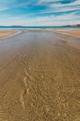 beautiful scenary of the Brown River estuary meeting the Pacific Ocean and golden sand of Kingston Beach in Southern Tasmania
