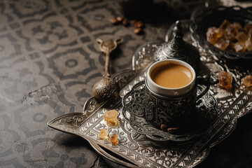 Coffee in metal Turkish traditional cup and coffee beans on dark tile background - Powered by Adobe