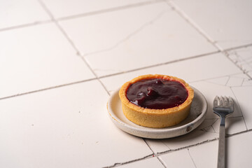 Mini tart with whipped cream cherry and lemon sweet dessert on white plate