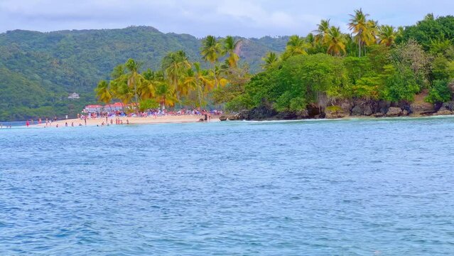 People on beach of Cayo Levantado or Bacardi island seen from boat during navigation, Samana in Dominican Republic
