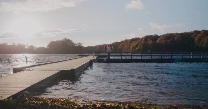 Bridge By Gyllebo Lake With Life Saving Bouy By The Autumn Sunset - Static Wide Shot