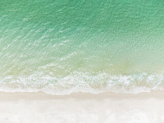 Fototapeta na wymiar Overhead view of the white sand and surf at .Chinamans beach in NSW, Australia