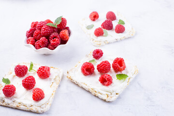 Toast with cream cheese and fresh raspberries. A delicious summer dish for breakfast.