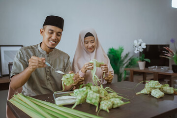 couple making ketupat for eid mubarak together