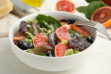 Bowl of delicious sicilian orange salad on white wooden table, closeup