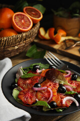 Plate of delicious sicilian orange salad on wooden table, closeup