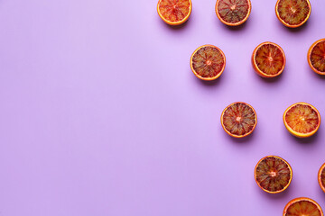 Obraz na płótnie Canvas Many ripe sicilian oranges on violet background, flat lay. Space for text