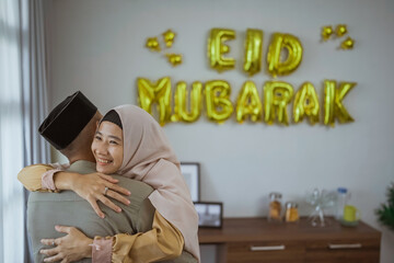 muslim couple embracing each other during eid mubarak