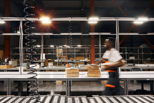 African factory worker delivering box at the storage