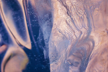 Air bubbles rising from the bottom froze in transparent blue ice. Optical distortion and refraction...