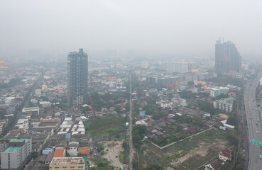 Aerial view of highway street road at Bangkok Downtown Skyline, Thailand. Financial district and business centers in urban city in Asia. Skyscraper buildings with fog. Air pollution pm2.5