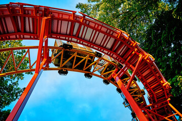 Part of looping roller coaster at summer day, Riding a rollercoaster at amusement park