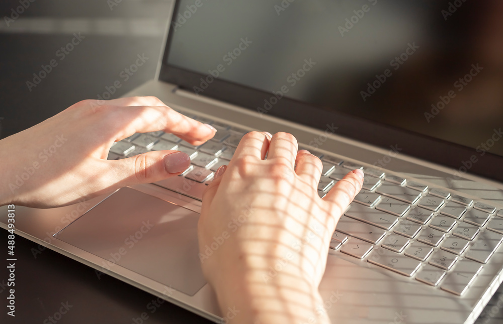 Poster female hands closeup typing on laptop keyboard. woman using computer in work or study. high quality 