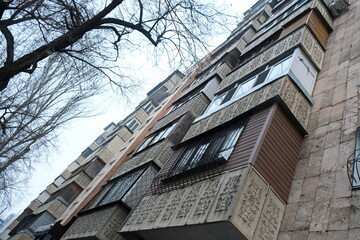Almaty, Kazakhstan - 01.23.2020 : A row of balconies of a residential high-rise building. Windows of residential apartments.