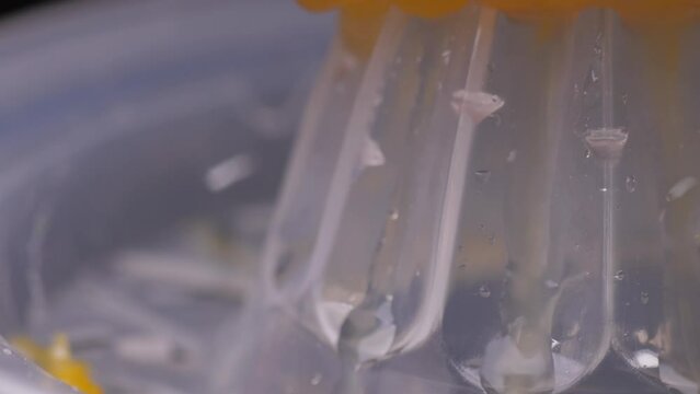squeezing orange using squeezer slow motion 4k
