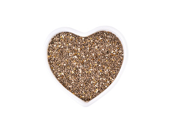 Black chia seeds in a heart shaped bowl isolated on white background. Superfood for healthy nutrition and diet, contains vitamins and minerals, salvia grains.