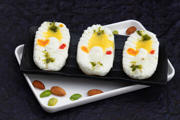 Cham Cham Mithai Also Called Rasgulla Malai Chaap, Chomchom Or Rosogolla Chamcham Is Made Of Milk, Mawa, Khoya, Pista, Kesar, Khova, Paneer, Chenna, Chhena, Dry Fruits Stuffing And Dunked In Chasni