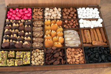 various nuts, candies and Turkish delight, stacked in the box.