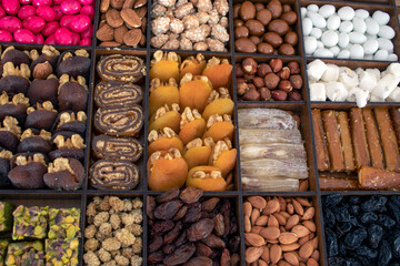 various nuts, candies and Turkish delight, stacked in the box.