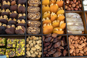 various nuts, candies and Turkish delight, stacked in the box.