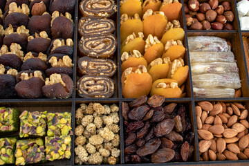various nuts, candies and Turkish delight, stacked in the box.