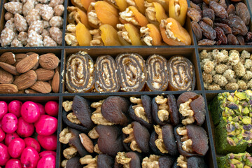 various nuts, candies and Turkish delight, stacked in the box.