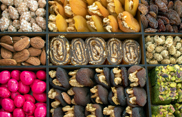 various nuts, candies and Turkish delight, stacked in the box.