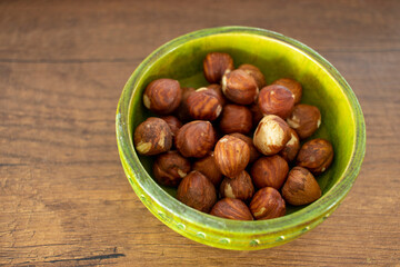 hazelnut kernels, isolated on wooden surface.. close-up