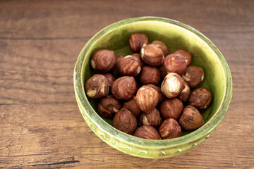 hazelnut kernels, isolated on wooden surface.. close-up