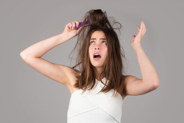 Hair loss problem treatment. Portrait of woman with a comb and problem hair.