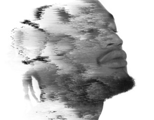 A double exposure portrait of a man combined with digital art.