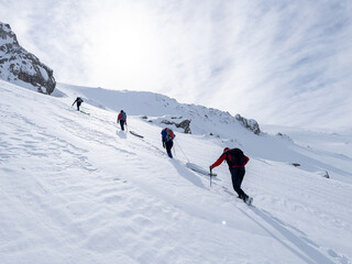 Fototapeta na wymiar Mountaineers hiking in the avalanche area