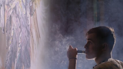 Artist designer draws an eagle on the wall. Craftsman decorator paints a picture with acrylic oil color. Vaper smokes vape. Painter painter dressed in a paint coat. Indoor. Dark magic cinematic look.