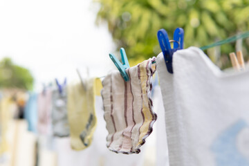 Selective focus on Baby laundry hanging on a clothes line