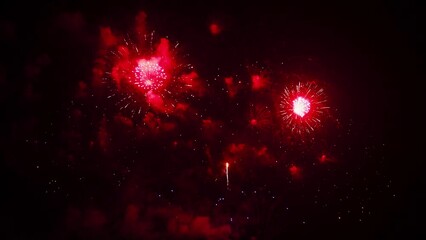 Beautiful colorful real continue fireworks display celebration in New year's eve with an abstract blur of golden shining with bokeh lights in the night sky.